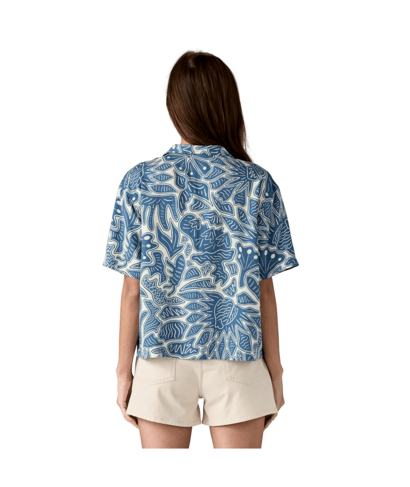 Blue and white botanical print short-sleeve shirt shown from back view with beige shorts