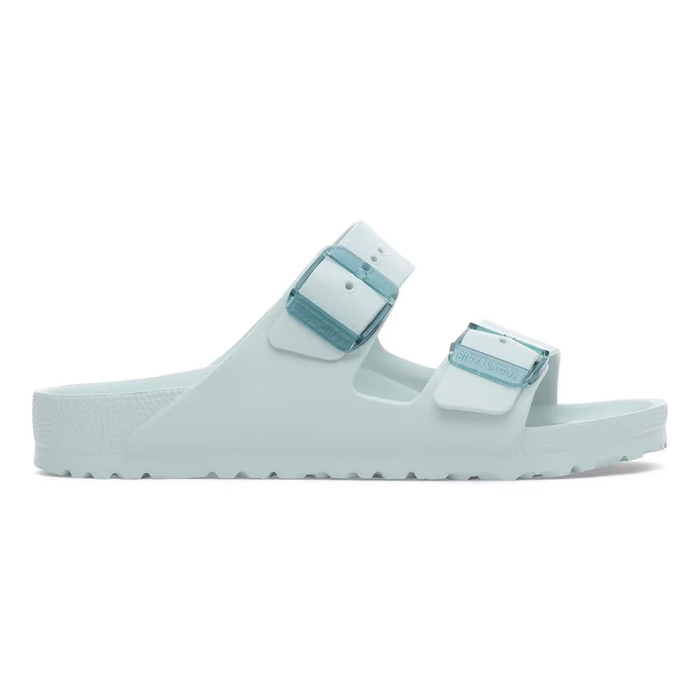 Light green two-strap sandal with buckles and contoured footbed, side view