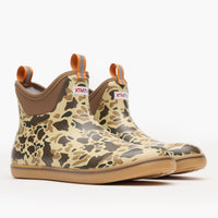 Ankle-height rubber deck boots in camouflage pattern with orange pull tabs and gum sole, three-quarter view