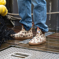 Camouflage ankle deck boots with rubber sole worn on wet boat deck, side view