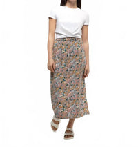 Long midi skirt with abstract floral pattern, worn with white twisted tee and sandals