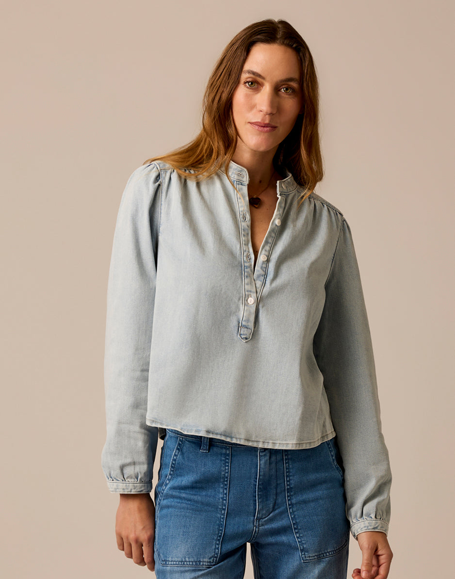 Women's lightweight denim pullover top with button placket and long sleeves, front view