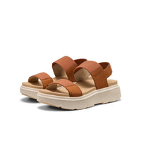 Brown leather platform sandals with adjustable straps and chunky white sole, three-quarter view