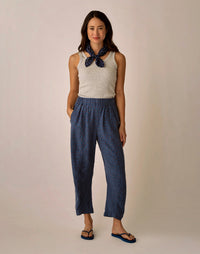 Navy blue patterned linen pants with elastic waistband worn with gray tank top