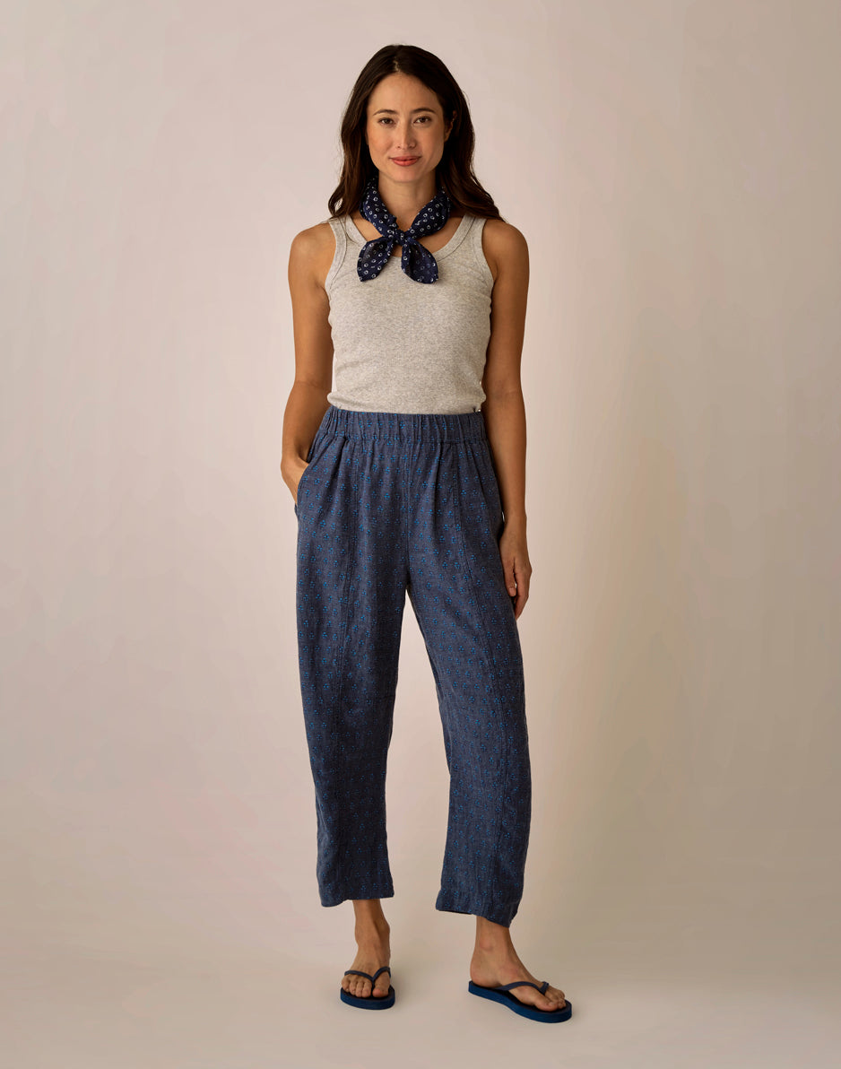 Navy blue patterned linen pants with elastic waistband worn with gray tank top