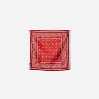 Red bandana towel with white paisley pattern and ornate border design, flat lay view