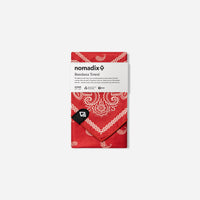 Red bandana towel with white paisley pattern in product packaging