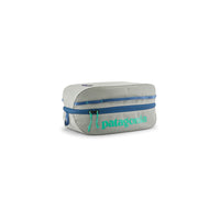 Compact rectangular travel cube bag with blue zipper and teal logo, three-quarter view
