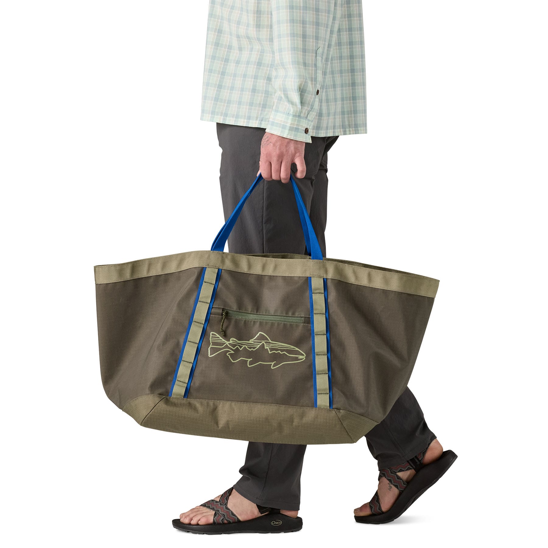 Large olive green tote bag with blue handles being carried, featuring fish logo
