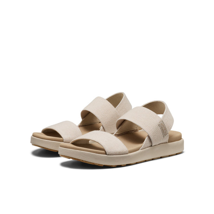 Light beige canvas strap sandals with backstrap design and cushioned sole, side angle view