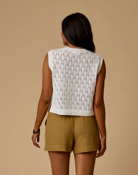 White open-knit cropped sweater vest with diamond lace pattern, back view on model