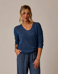 Woman wearing blue textured knit v-neck pullover sweater with long sleeves