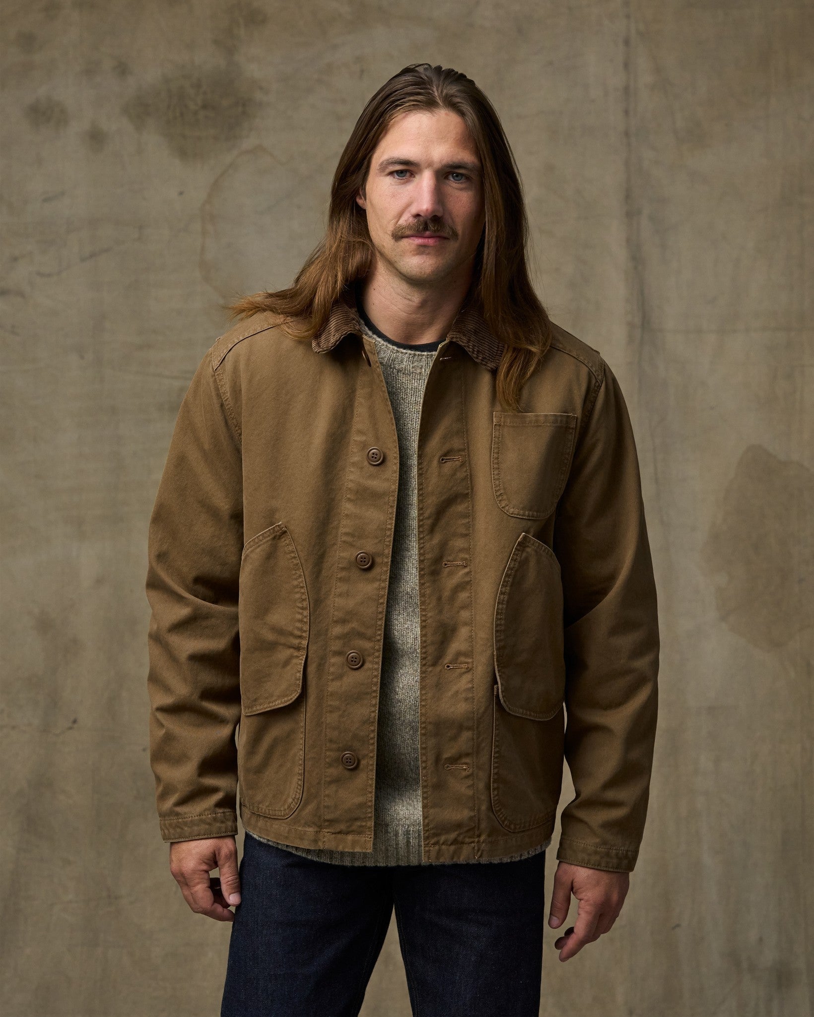 Men's canvas chore jacket in tan brown with corduroy collar and multiple pockets, front view
