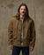 Men's canvas chore jacket in tan brown with corduroy collar and multiple pockets, front view