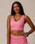 Women's striped pink and white crop tank top with V-neckline, front view on model