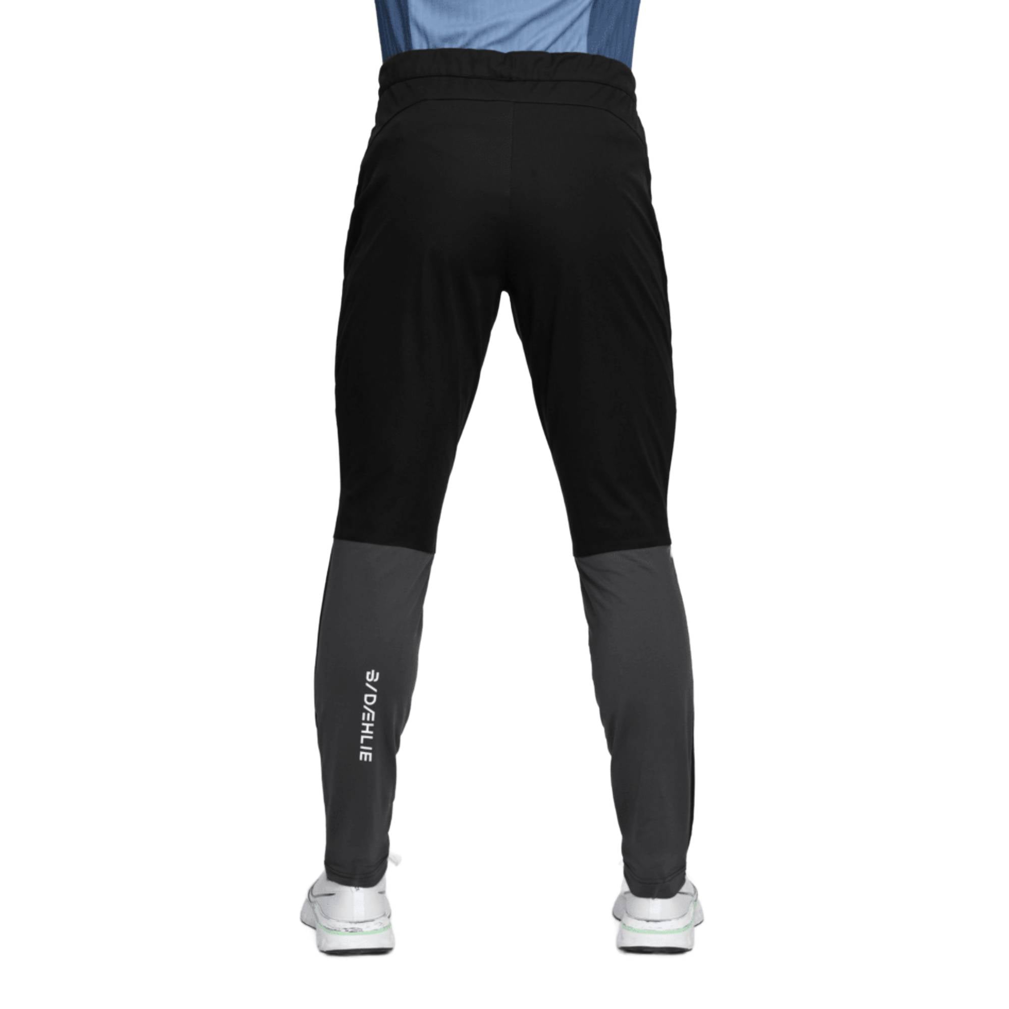 Men's athletic running pants, back view, black with dark grey lower leg panels
