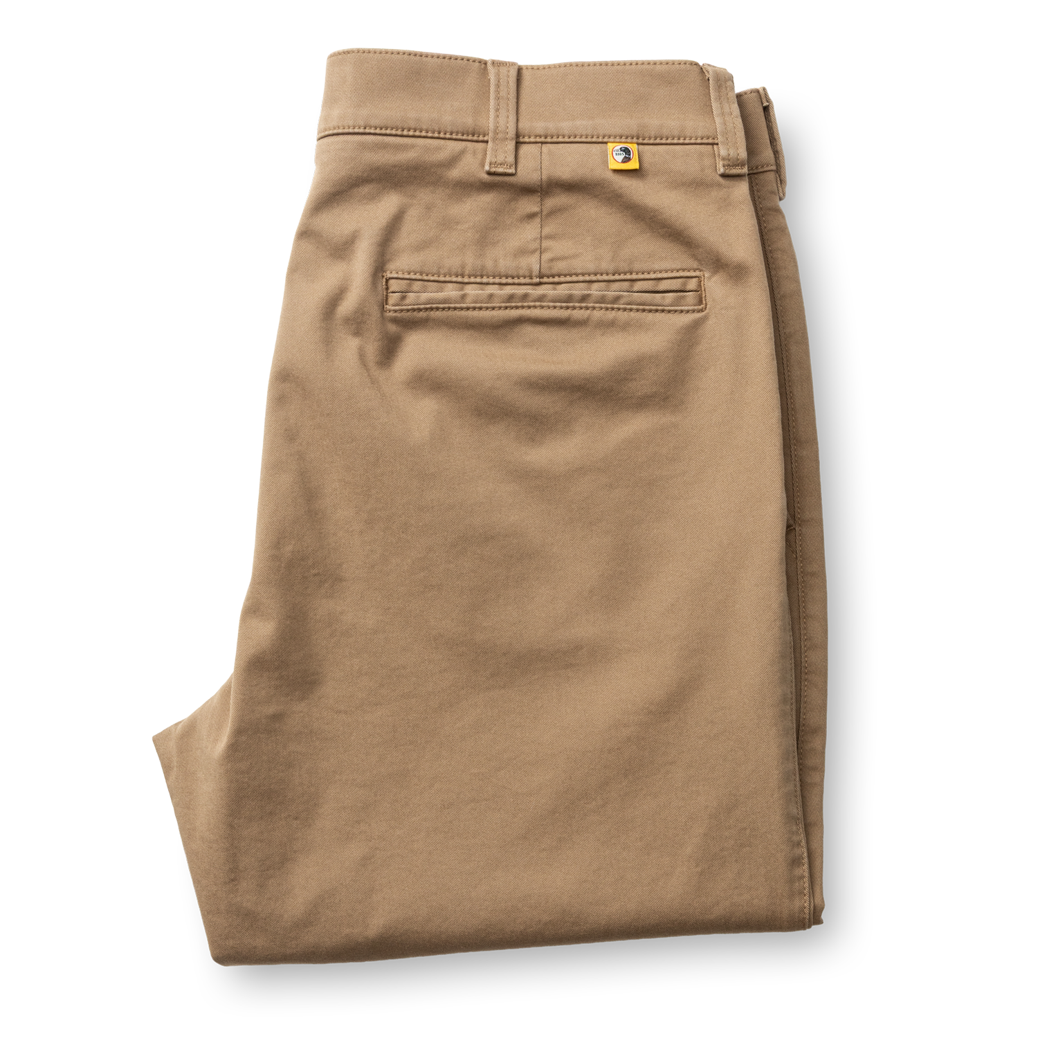 Folded classic fit chino pants in tan, showing back pocket and belt loops