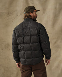 Men's black quilted puffer jacket, back view, with ribbed cuffs and collar