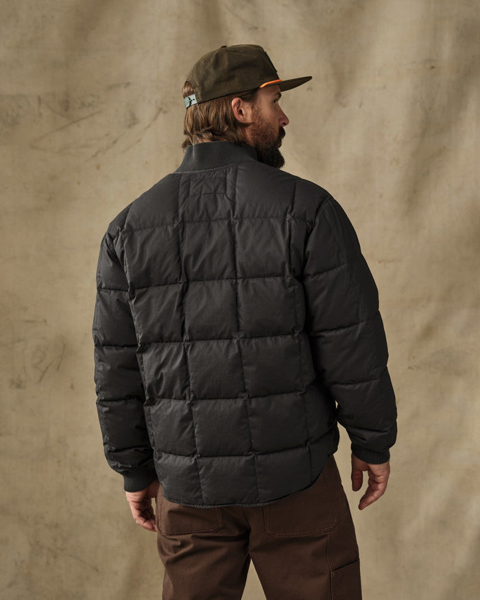 Men's black quilted puffer jacket, back view, with ribbed cuffs and collar