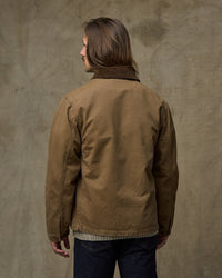 Men's canvas work jacket in tan brown with corduroy collar, back view on model