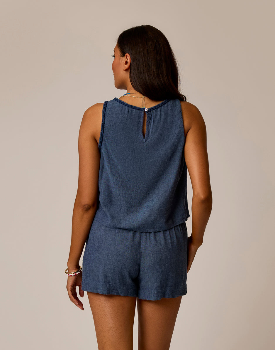 Blue chambray sleeveless romper with elastic waist and keyhole back detail, back view