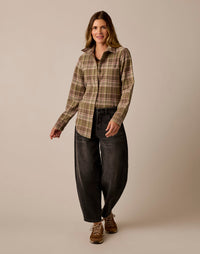 Women's plaid flannel button-up shirt in olive green tartan, full front view on model