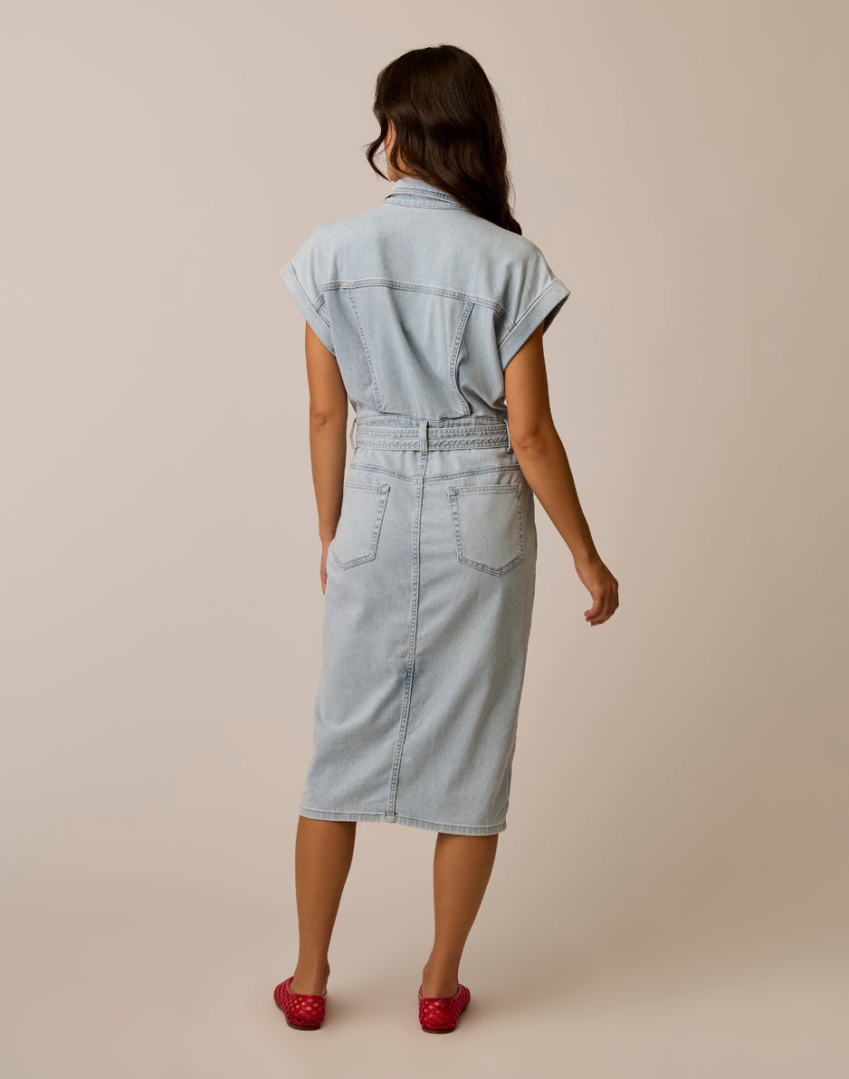 Women's sleeveless denim shirt dress with belt and back pockets, back view on model