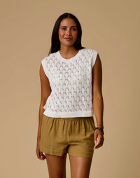 Women's sleeveless open-knit sweater vest in off-white with diamond pattern, front view