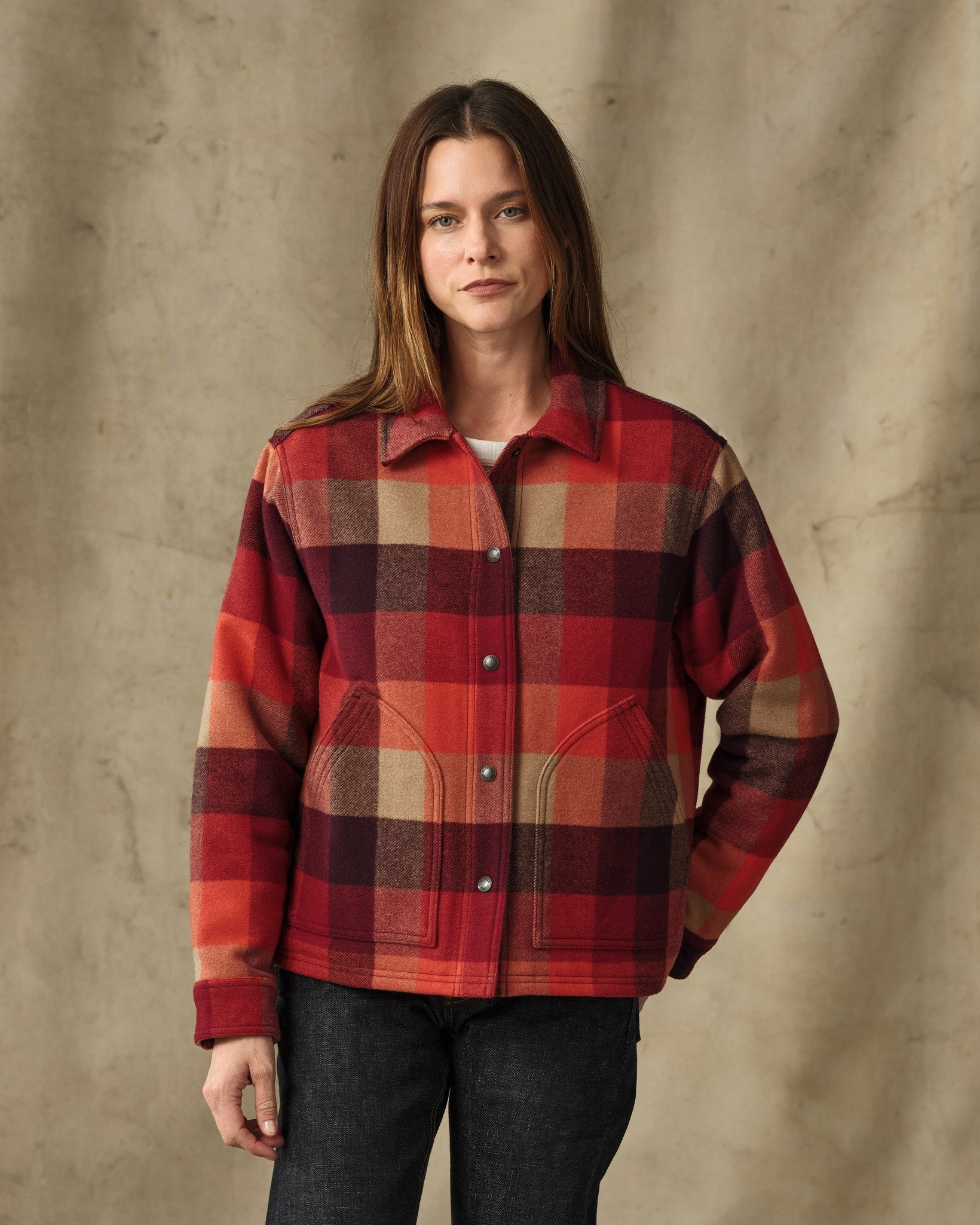Women's plaid wool shirt jacket in red and burgundy check, front view with snap buttons