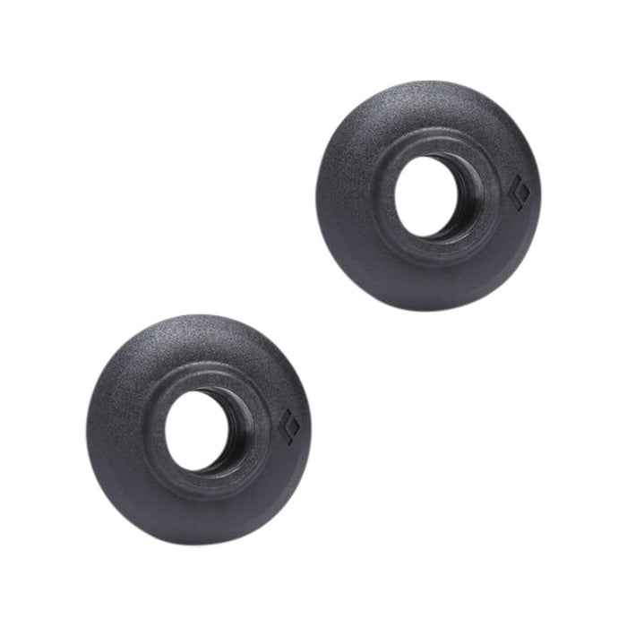 Pair of round black trekking pole baskets with central hole, top-down angle