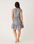 Gray sleeveless tiered dress with small white floral print, shown from back view