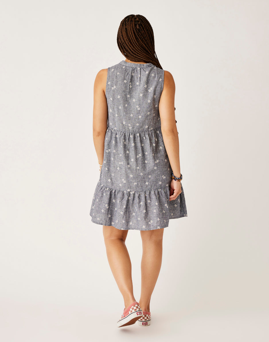 Gray sleeveless tiered dress with small white floral print, shown from back view