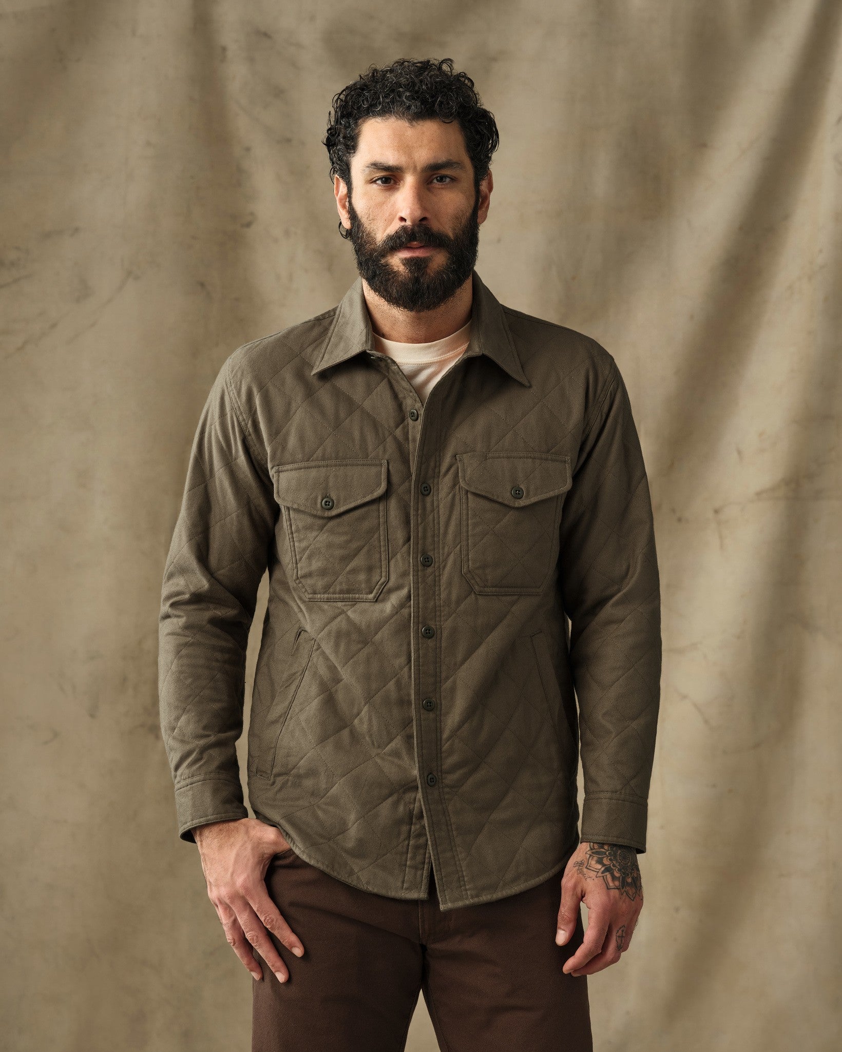 Men's quilted insulated shirt jacket in olive green with chest pockets, front view