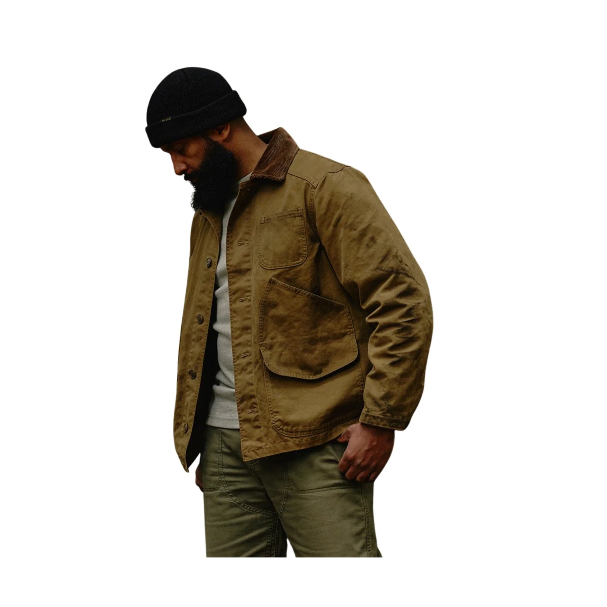 Men's canvas chore coat in tan with brown collar, large chest pockets, button front, on model