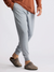 Men's grey jogger pants with drawstring waist and cuffed ankles, side view on model