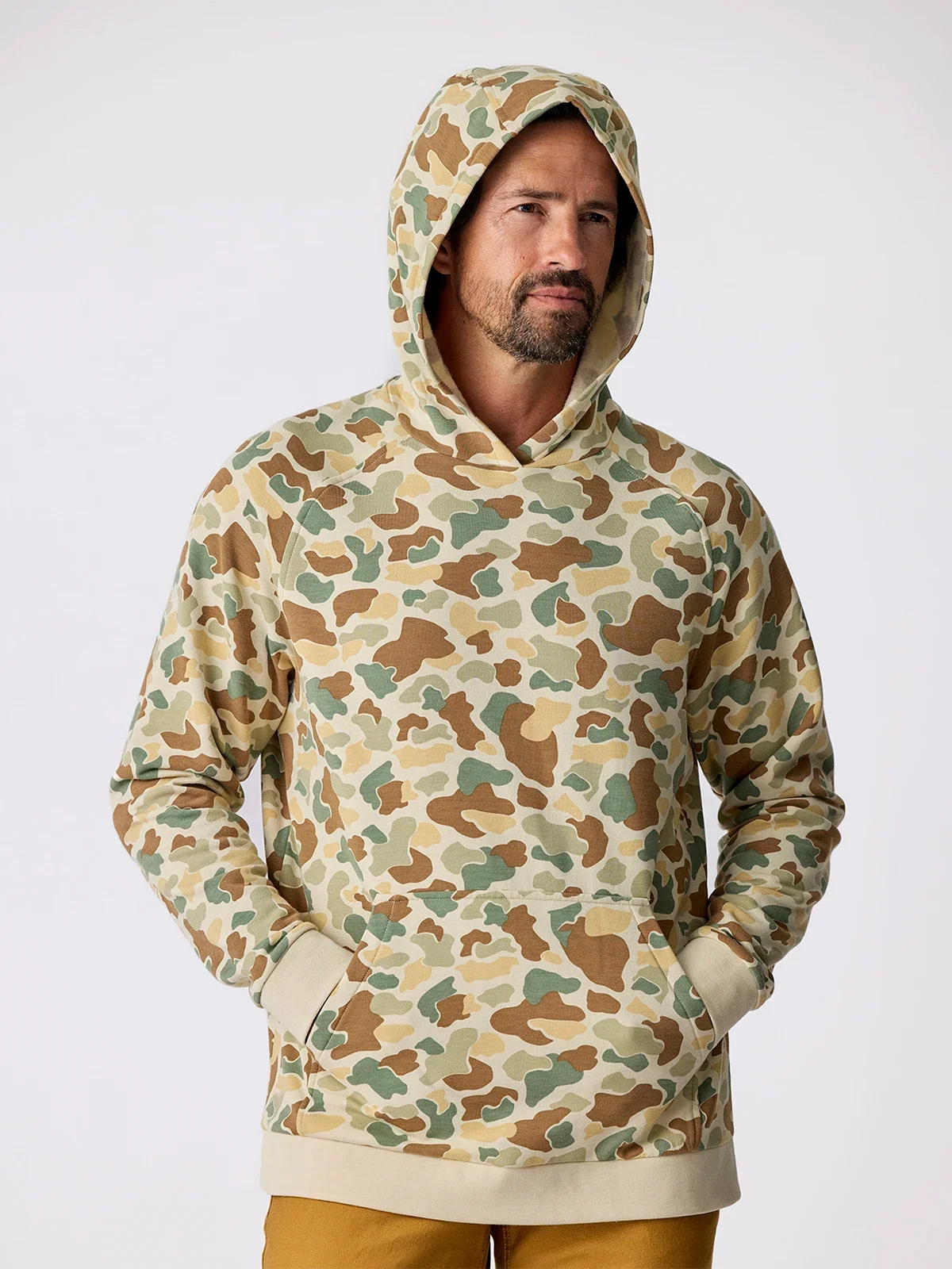 Men's camouflage pullover hoodie with kangaroo pocket, front view on model