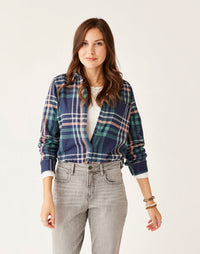 Women's plaid flannel button-up shirt in navy and green tartan, front on-model view
