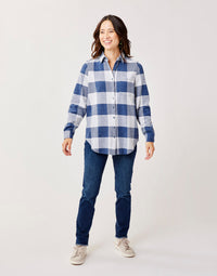 Women's oversized plaid flannel button-up shirt with chest pocket, worn with dark jeans, front view