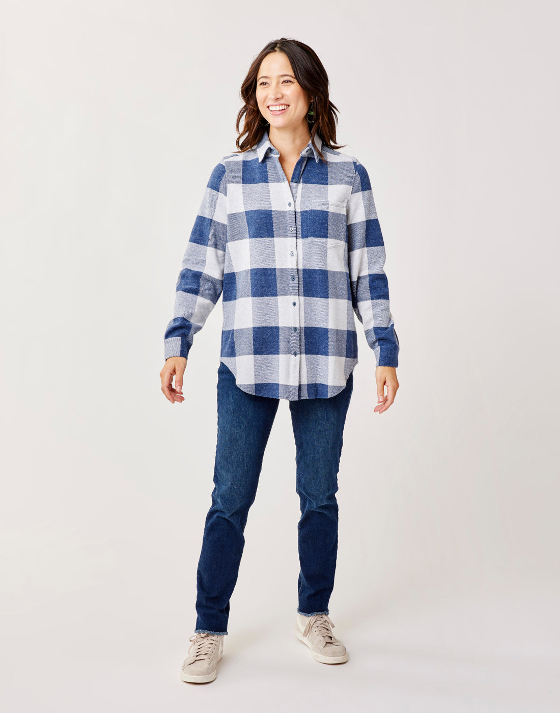 Women's oversized plaid flannel button-up shirt with chest pocket, front view on model