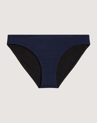 Reversible bikini bottom with navy blue front panel and black side panels, flat lay view