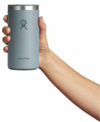 Hand holding a tall insulated tumbler cup with lid, shown from the front