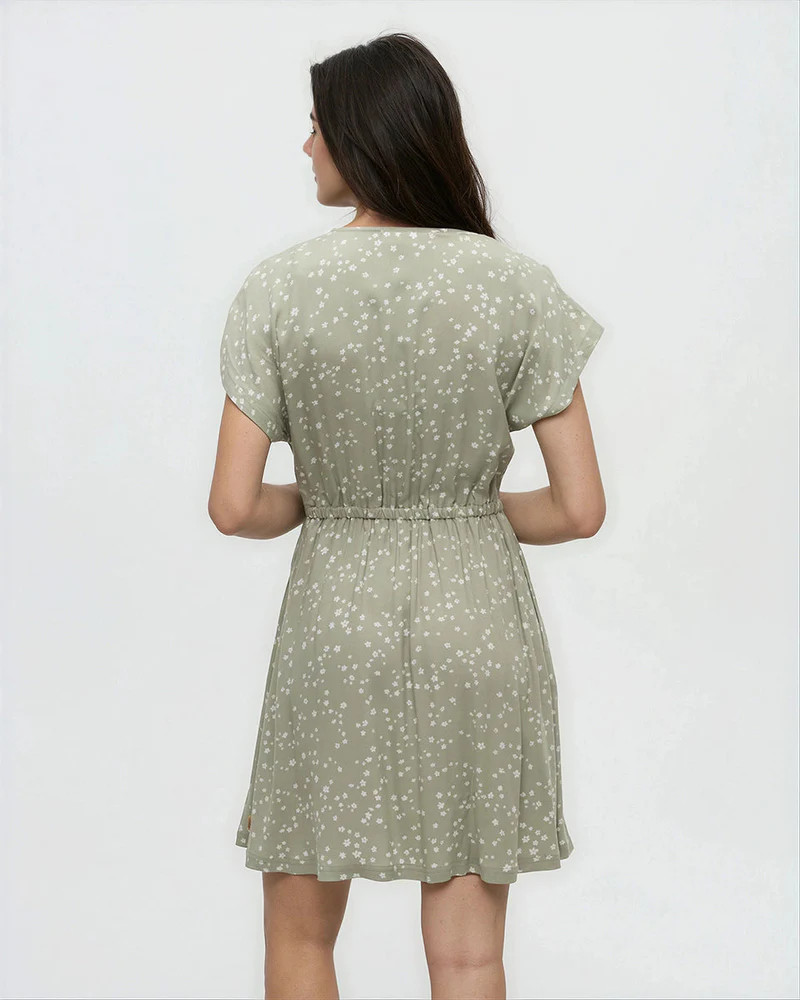 Light green dress with small white floral print, short sleeves, elastic waist, back view