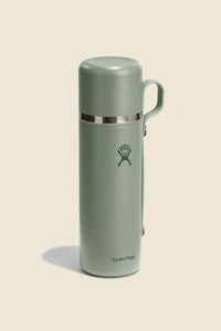 Insulated stainless steel thermos flask with attached cup lid and handle, front view