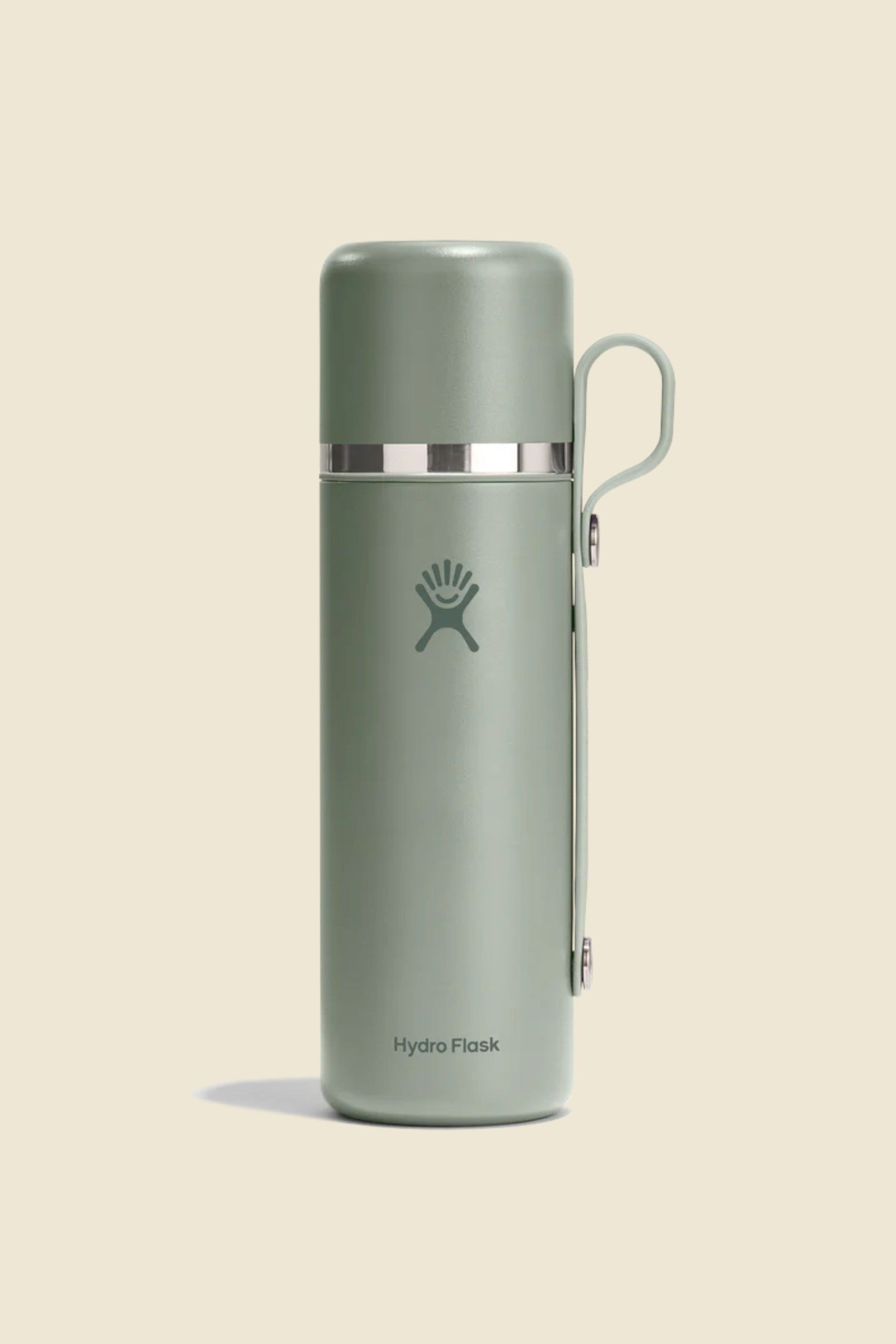 Insulated stainless steel thermos with attached cup lid and carry loop, front view
