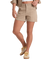 Beige high-waisted cargo shorts with button closure and rolled cuffs, worn with matching shirt