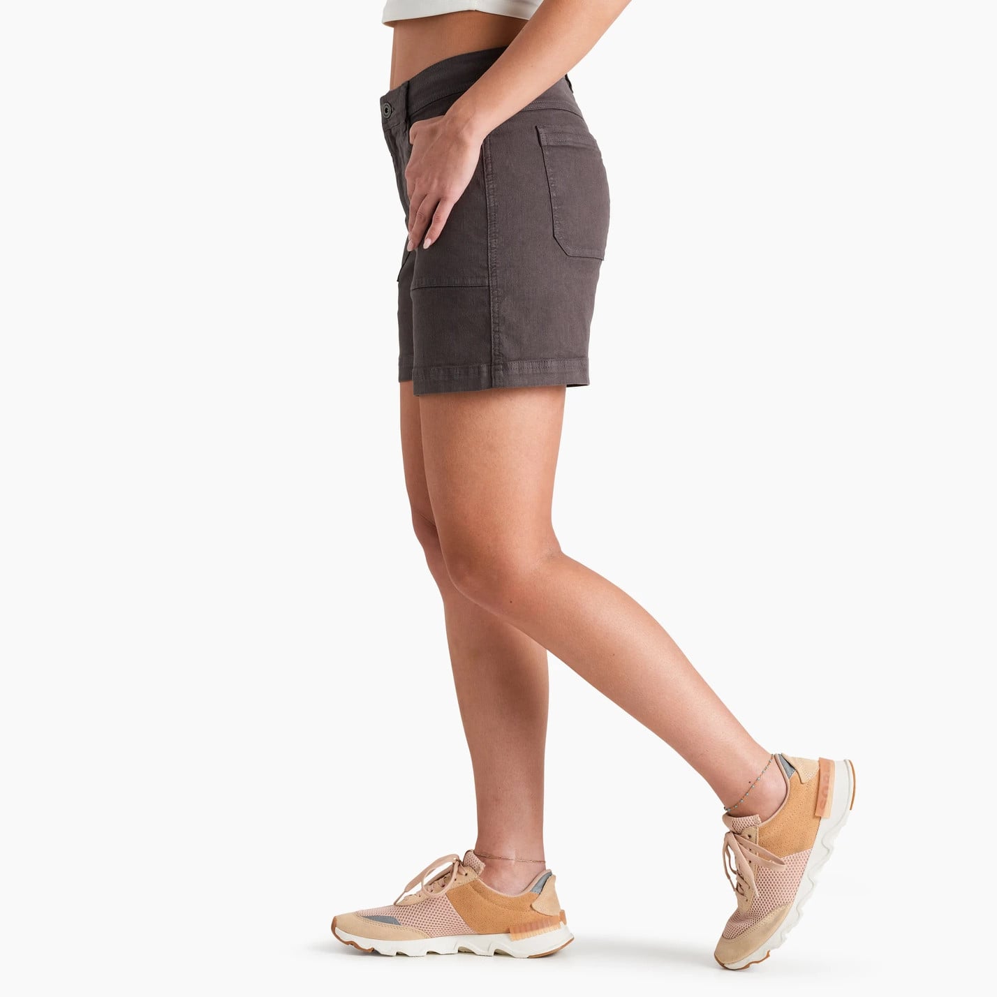 Women's dark gray casual shorts with patch pockets, side view, paired with tan sneakers