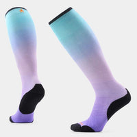 Knee-high ski socks with teal-to-purple ombre gradient, black reinforced heel and toe, front and back views