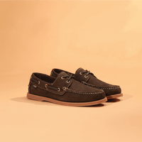 Dark brown nubuck leather boat shoes with lace detail, contrast stitching, and gum sole, three-quarter view