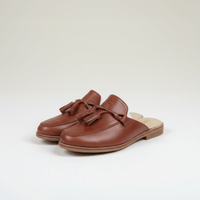 Brown leather tassel mule loafers with flat sole, three-quarter view, backless style