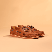 Brown leather boat shoes with woven texture and laces, side angle view